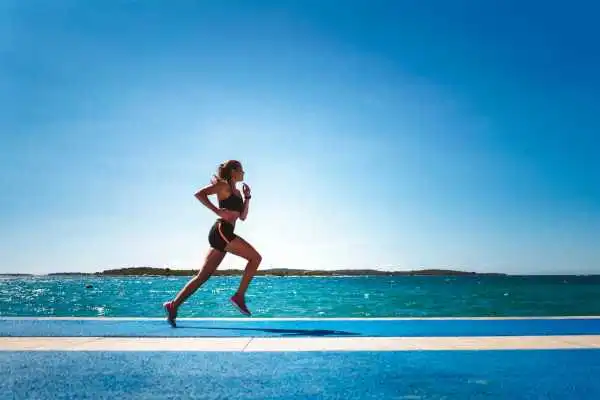Woman running showing strong leg muscle Bere Regis